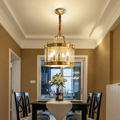  Modern copper chandelier with glass accents, hanging in a luxurious dining room setting. Golden Atelier 2