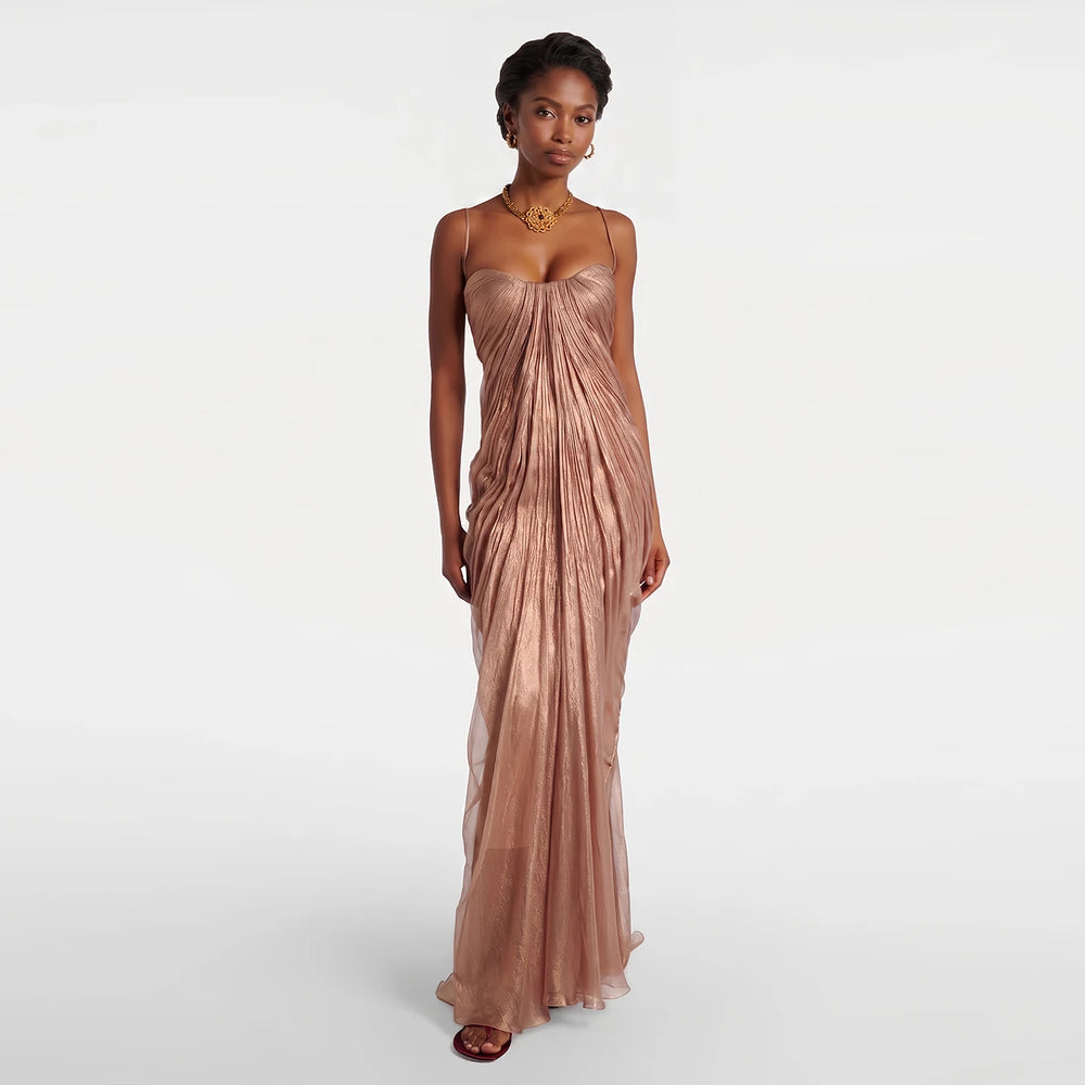 Model wearing a floor-length ruched spaghetti strap evening gown.