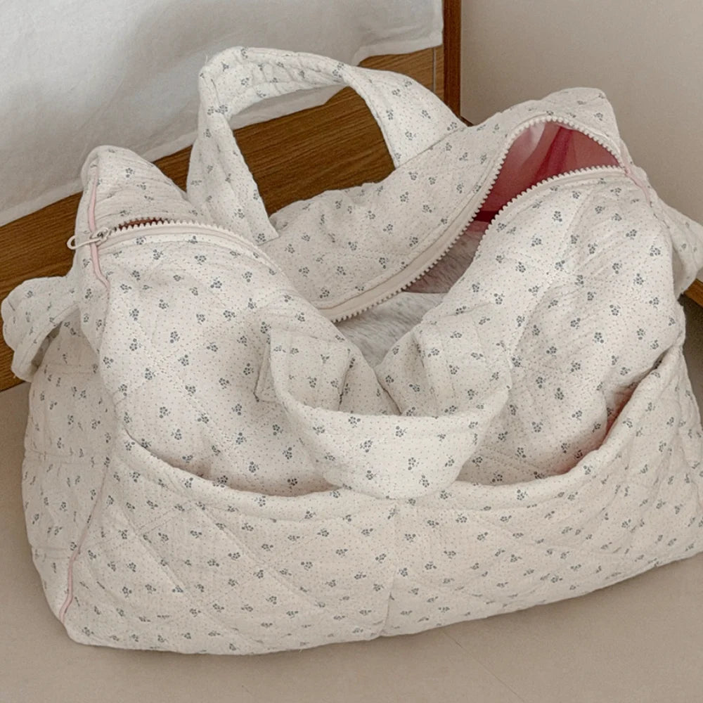Quilted floral print duffle top, showing exterior pockets