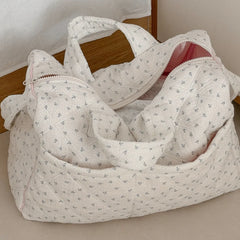 Quilted floral print duffle top, showing exterior pockets