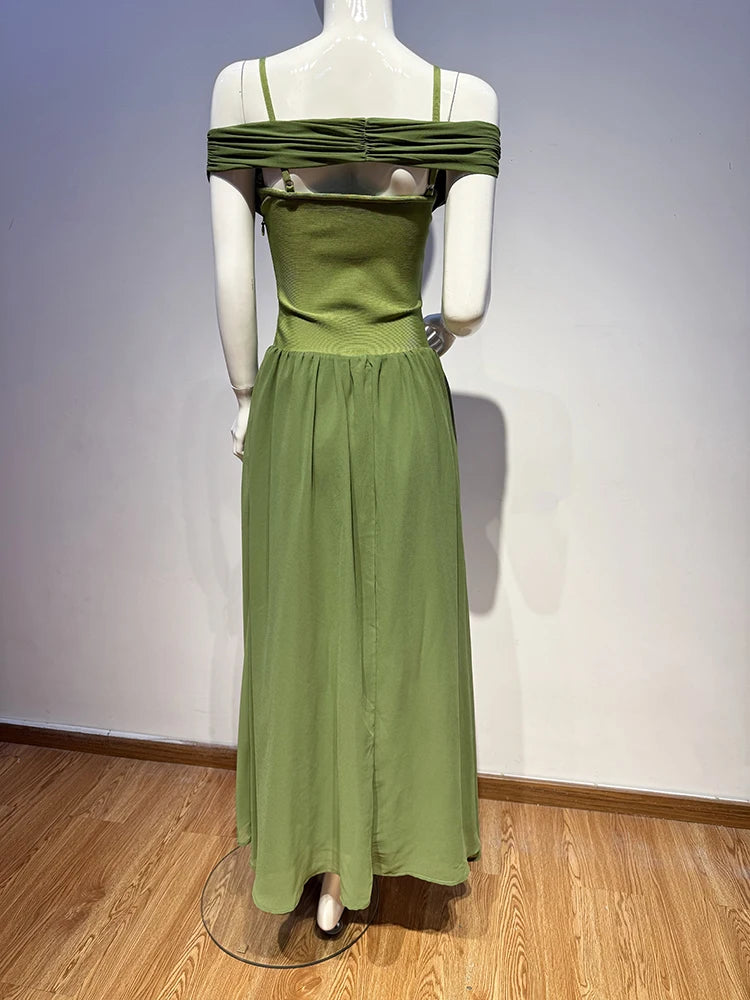 Green dress on a mannequin against a plain background