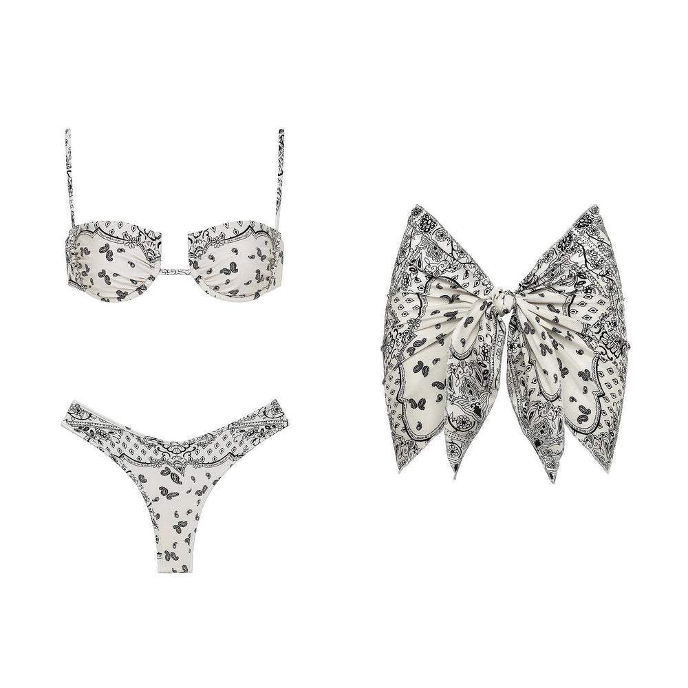 Paisley print bikini top, bikini bottoms, and large bow-shaped scarf arranged flat