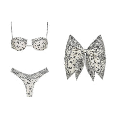 Paisley print bikini top, bikini bottoms, and large bow-shaped scarf arranged flat