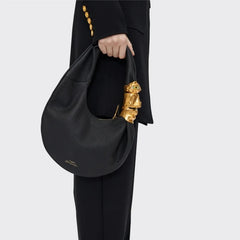 Black grained leather half moon shoulder bag with sculpted gold face hardware detail