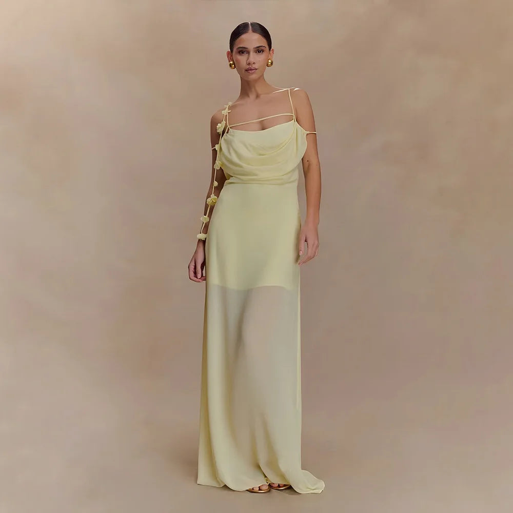 Woman wearing a light green evening gown against a beige background