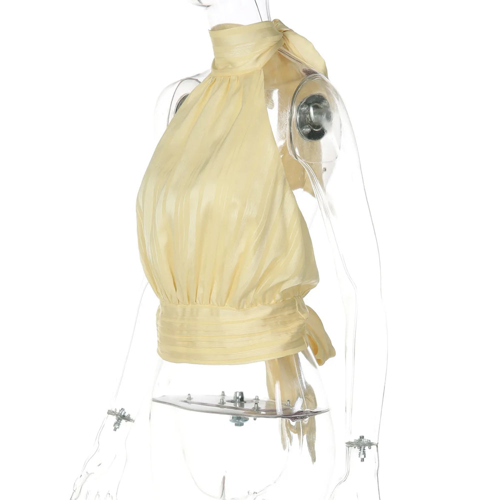 Mannequin wearing a yellow dress with a clear plastic cover on a white background