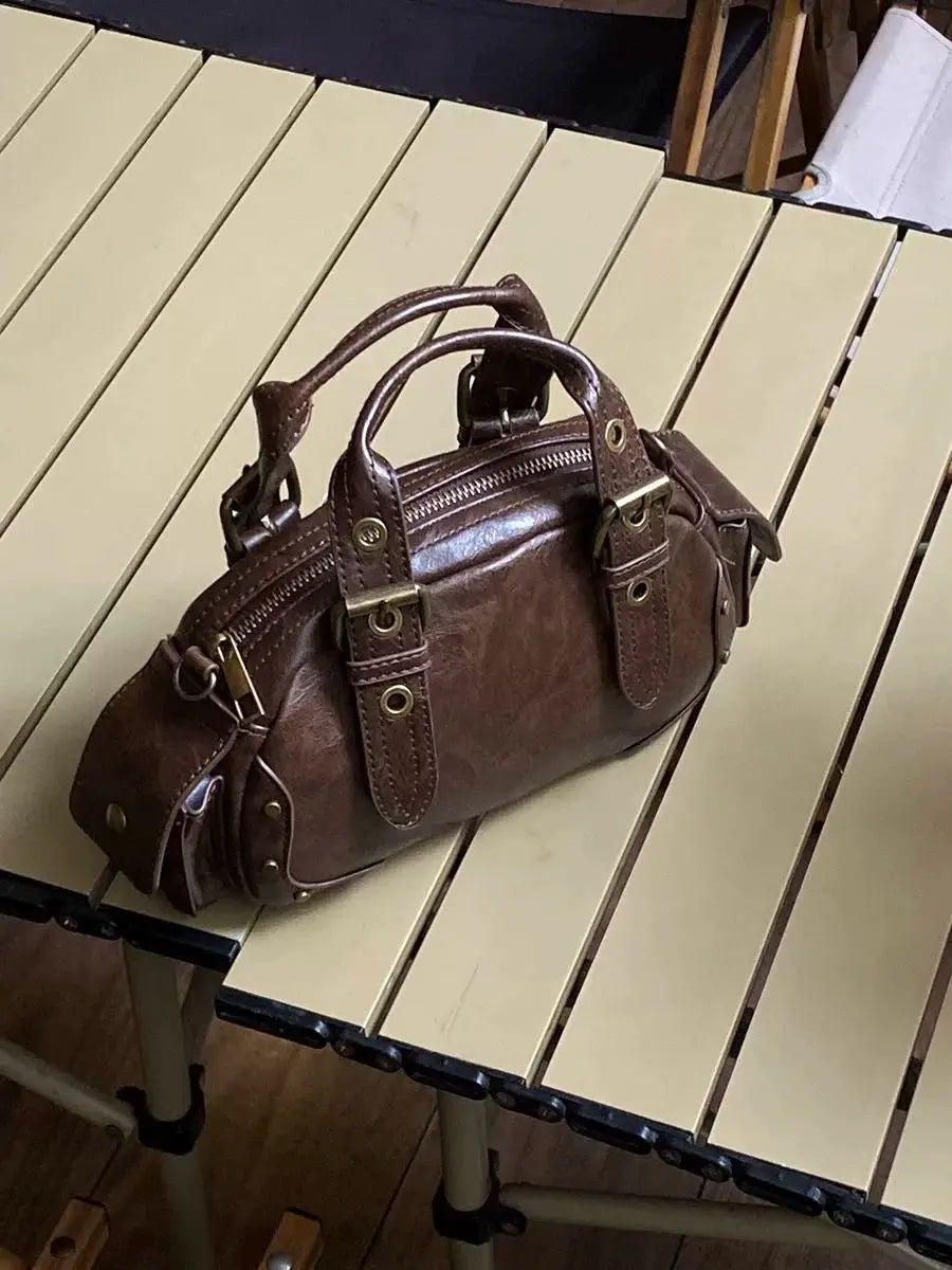 Brown leather handbag on a wooden table