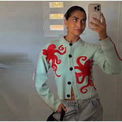 Close-up selfie of a person in an octopus jacquard knit cardigan