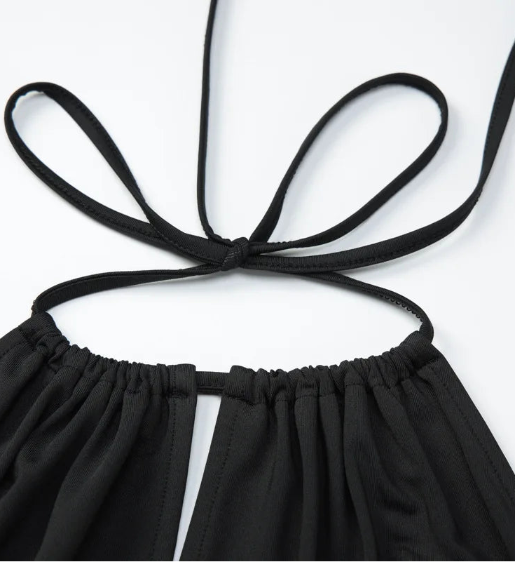 Black halter top with thin straps on a white background