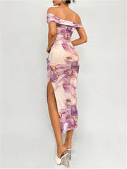 Woman wearing a floral off-shoulder dress with a high slit on a light gray background