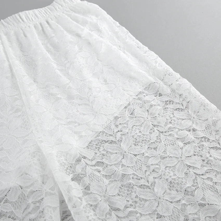 Close-up of white lace fabric on a gray background