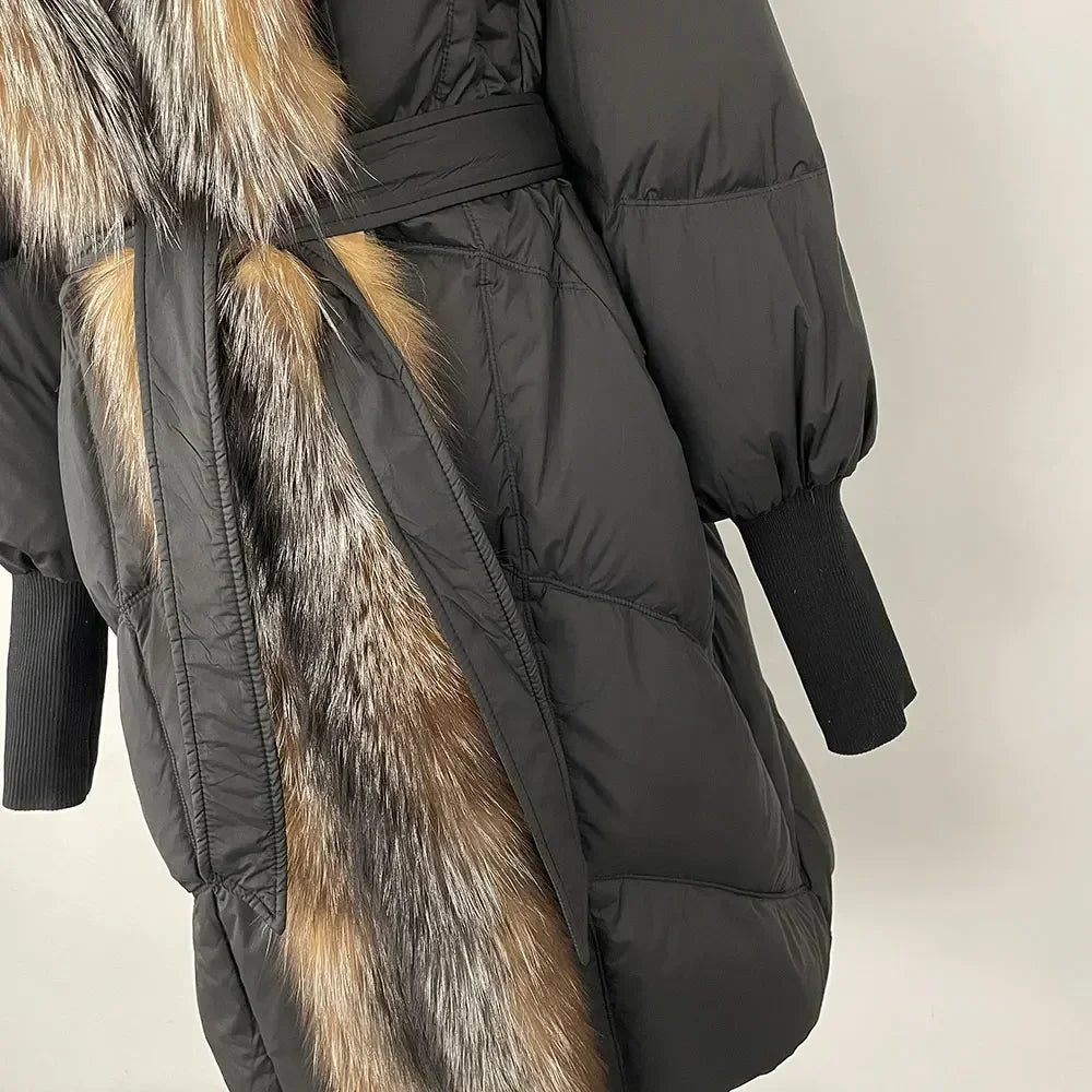 Black puffer coat with fur trim on a neutral background