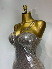 Side profile of a silver sequin column maxi dress on a mannequin.