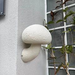  A lifestyle photo featuring the Golden Atelier White Mushroom Wall Sconce installed on a garden wall, adding a touch of enchantment to the space. 3