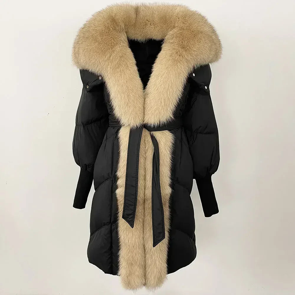 Black winter coat with beige fur trim on a white background