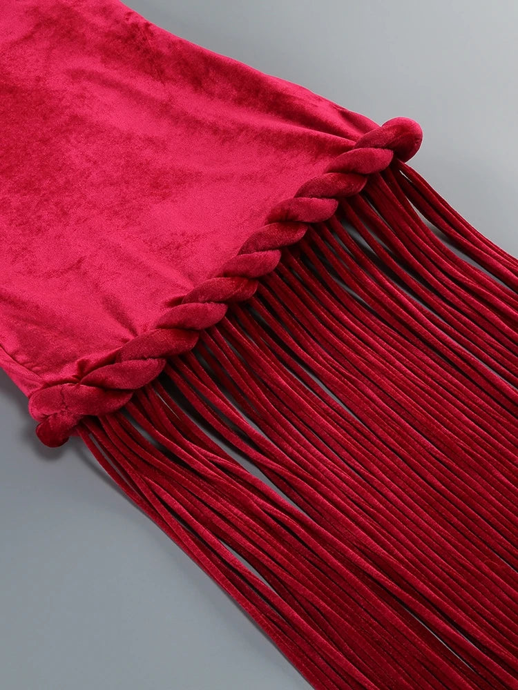 Close-up of a red fringed fabric on a gray background