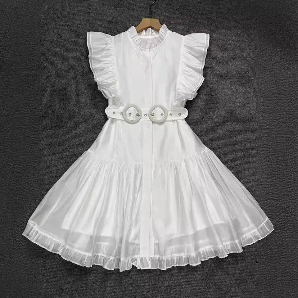 White dress with ruffled sleeves and a belt on a dark background