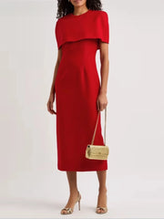 Woman wearing a red dress holding a straw handbag 