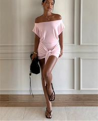 Full body view of off-the-shoulder draped mini dress