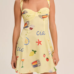 Yellow dress with colorful patterns and text on a plain background