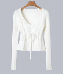 Close-up of the knitted texture and drawstring waist detail on a Golden Atelier short pullover. White A