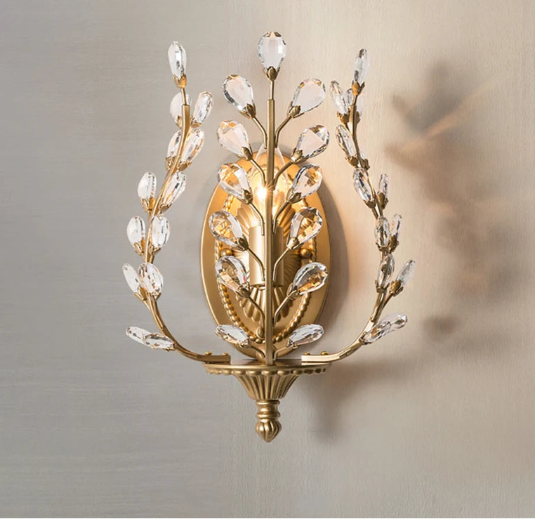 Decorative wall sconce with crystal accents on a neutral background