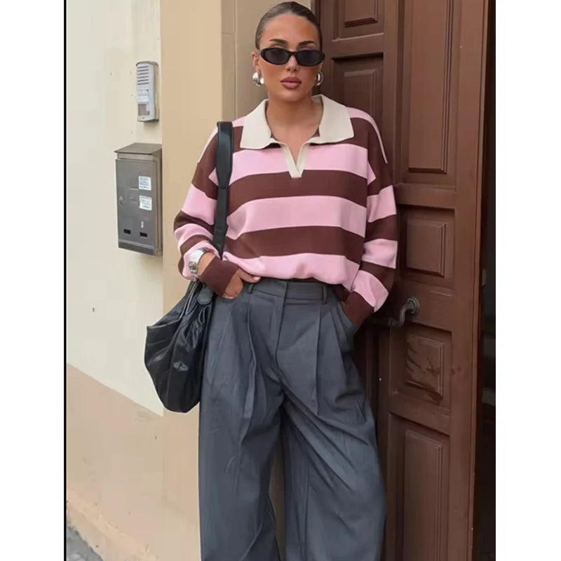Model wearing pink and red striped polo knit top
