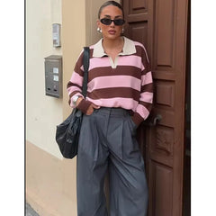 Model wearing pink and red striped polo knit top