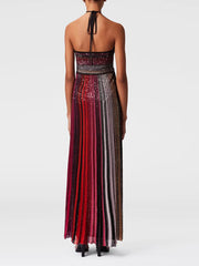 Long, multicolored dress with a halter neck on a white background