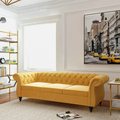 Yellow sofa in a living room with a cityscape painting on the wall.
