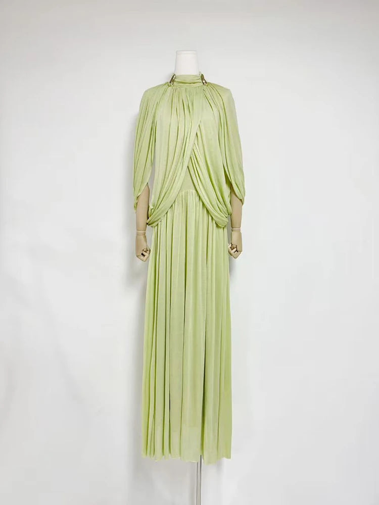 Light green evening gown on a mannequin against a white background