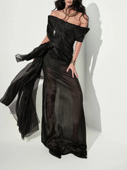 Black off-shoulder gown with sheer overlay on a white background