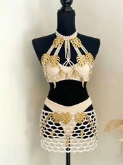 Mannequin displaying embellished mesh skirt and bikini top two-piece set with gold leaf details