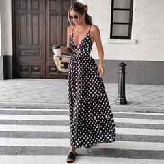 Woman in a black polka dot dress walking on a zebra crossing.