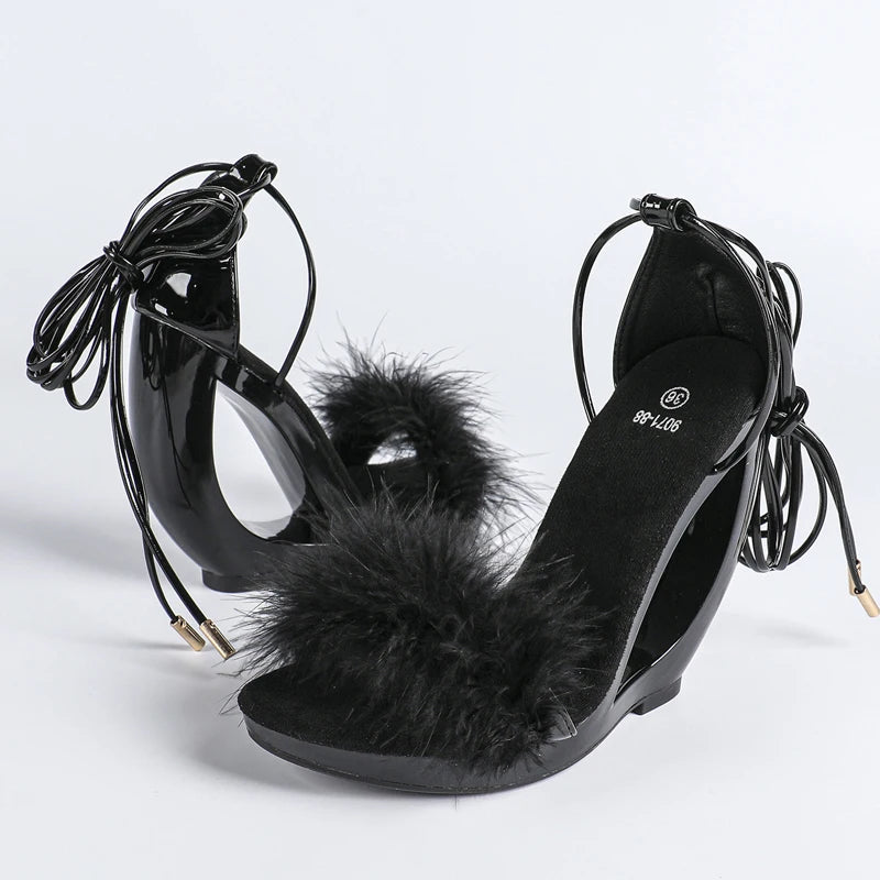 Black high-heeled sandals with fur details on a white background