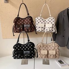 Four polka dot faux leather tote bags in various colors