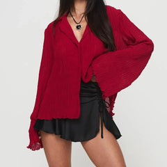 Person wearing a red blouse and black skirt on a white background