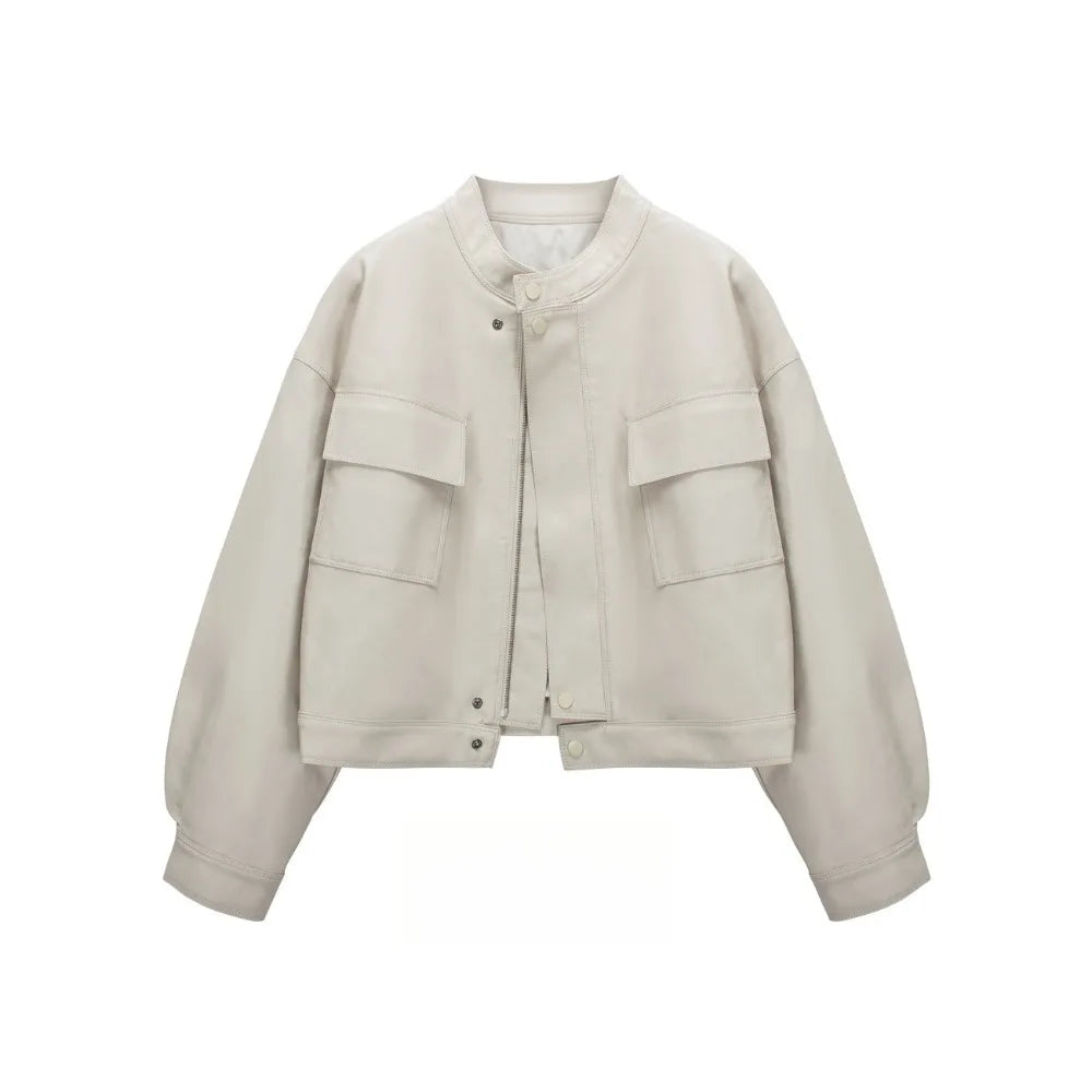 Beige cropped faux leather jacket with round neck and dual front pockets.