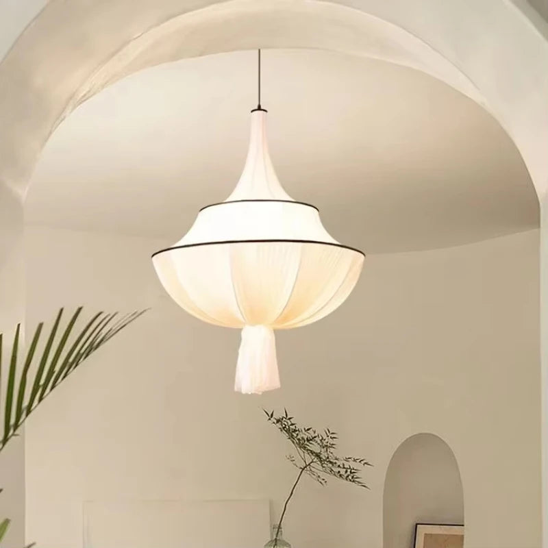 Art Deco satin chandelier with flowing textile shade and soft downlight in elegant modern foyer