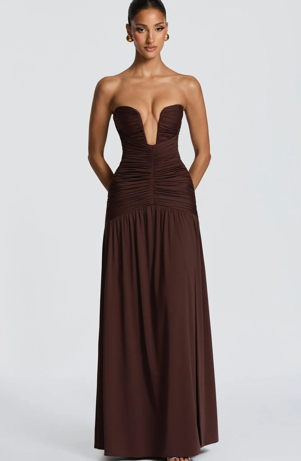 Brown strapless gown with a deep neckline on a white background