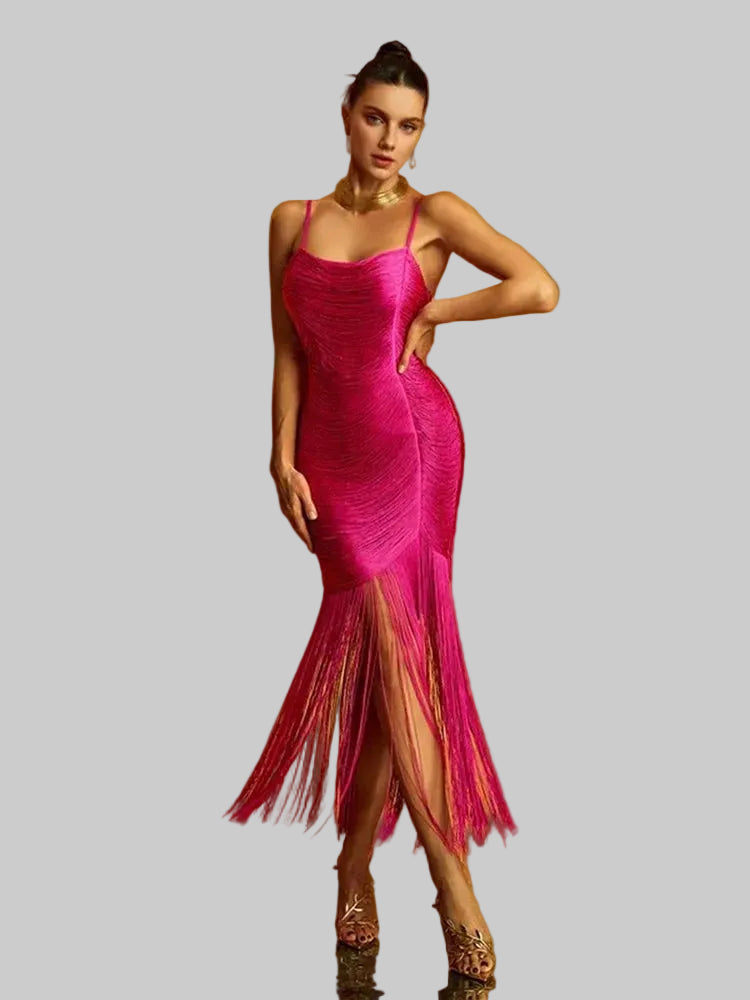 Woman wearing a pink fringe dress on a gray background