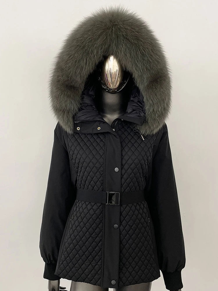 Black quilted coat with large fur hood on a mannequin against a white background