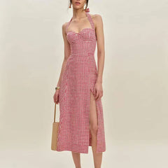 Woman wearing a red and white checkered dress with a beige background