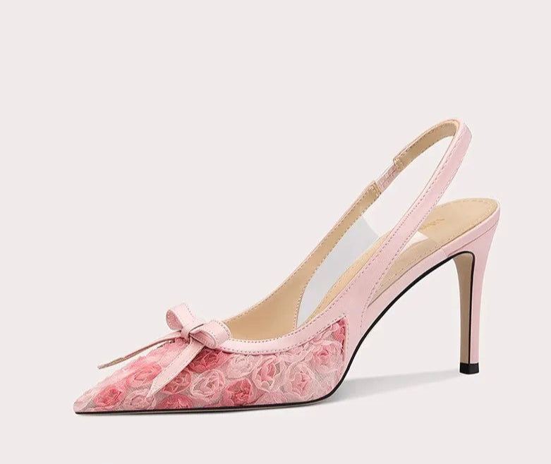 Pink high-heeled shoe with floral design on a white background
