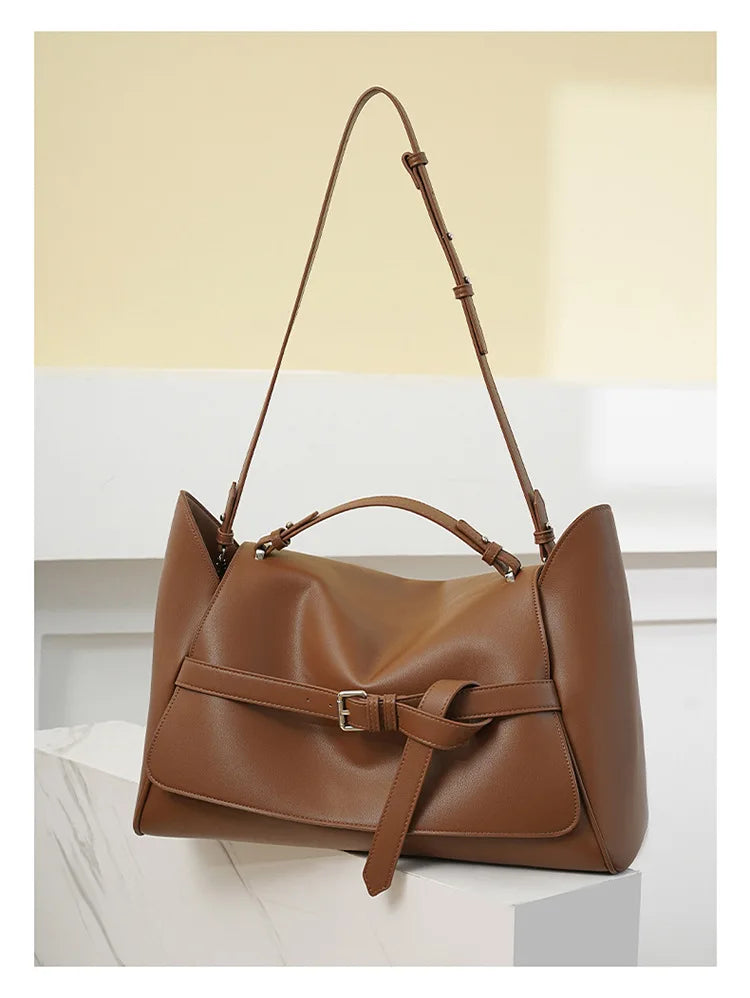 Brown leather handbag on a light background