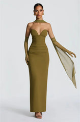 Woman wearing a green strapless gown with a white scarf on a white background