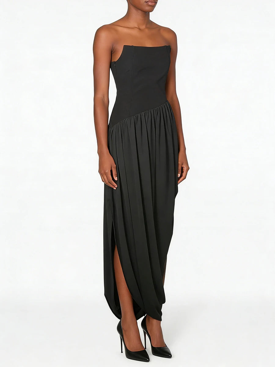 Black strapless gown with a slit on a white background