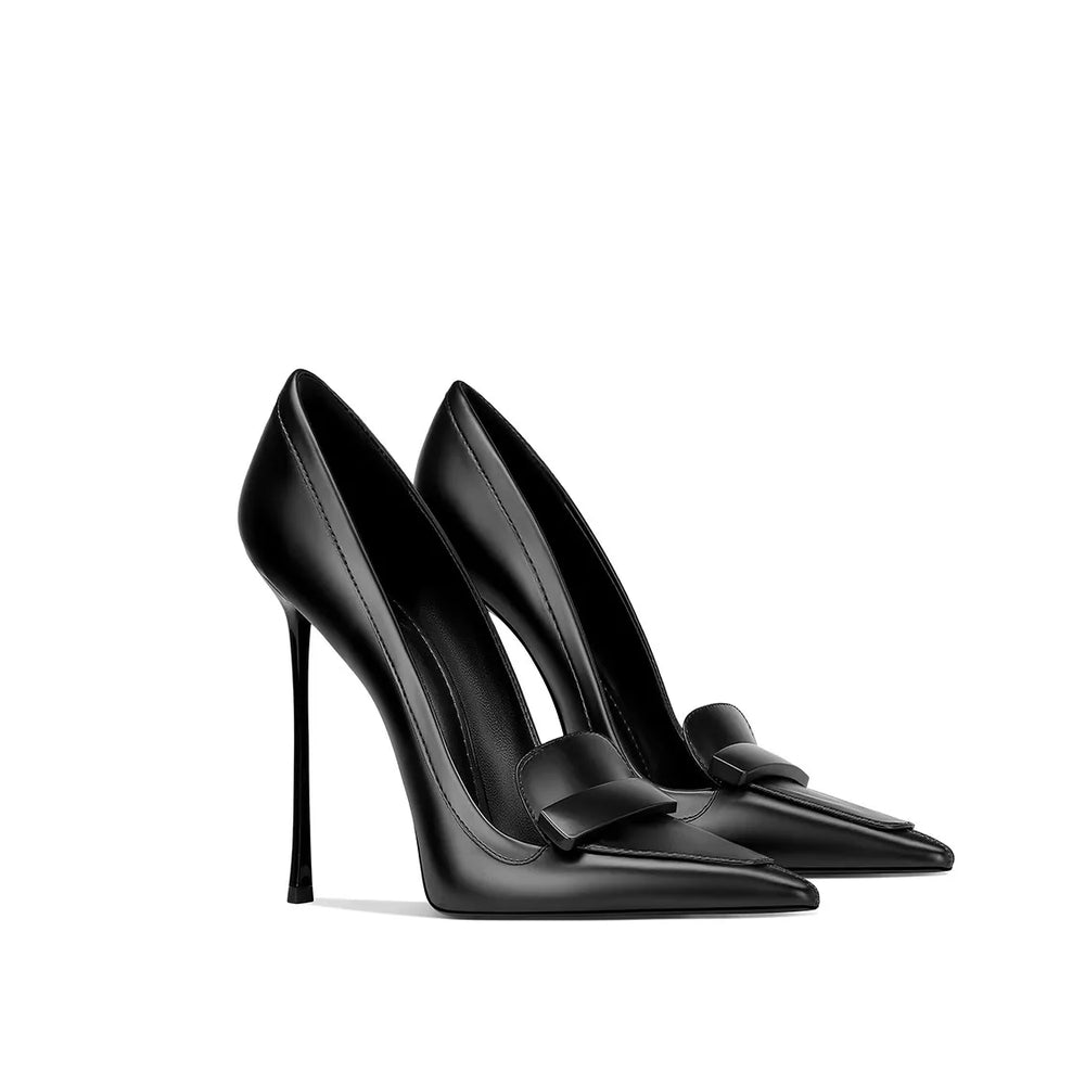 Black high-heeled shoes with bow details on a white background