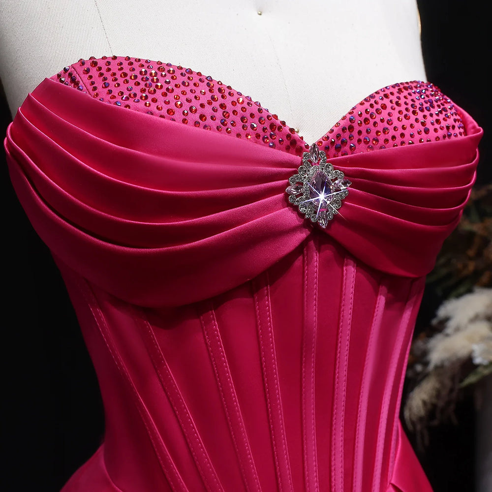 Pink strapless dress with embellishments on a mannequin