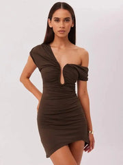Woman wearing a brown off-shoulder dress against a white background